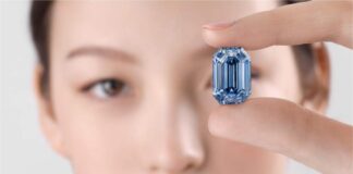 Model holding the 15.1-carat De Beers Blue diamond